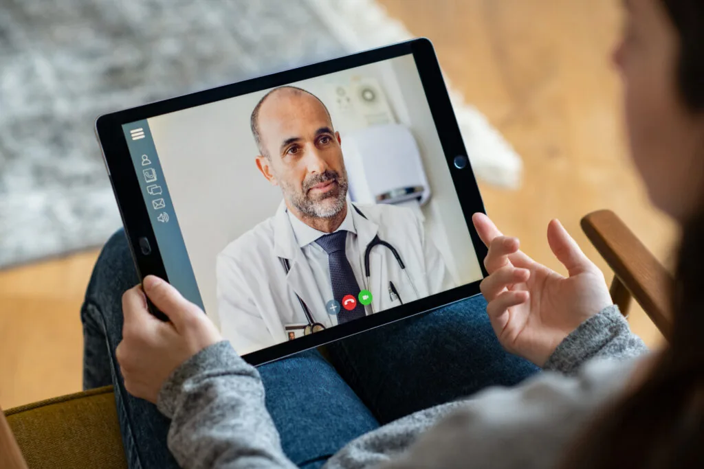 Back,View,Of,Woman,Making,Video,Call,With,Her,Doctor