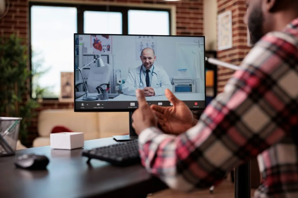 Young,Man,Talking,To,Doctor,On,Videocall,Telemedicine,Conference,On