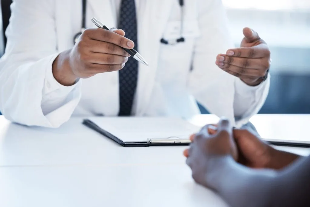 Hospital,,Clipboard,And,Hands,Of,Doctor,With,Patient,For,Discussion,