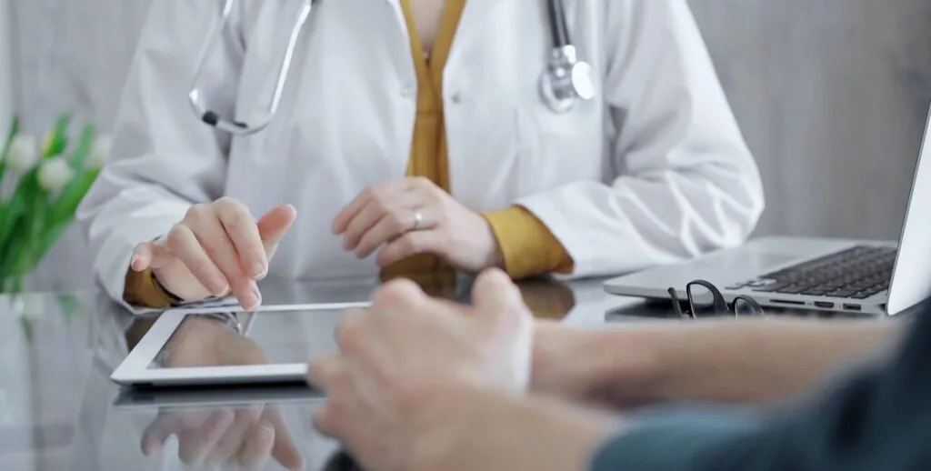 Doctor,And,Patient,Consultation,With,Digital,Tablet.,Close-up,View,Of